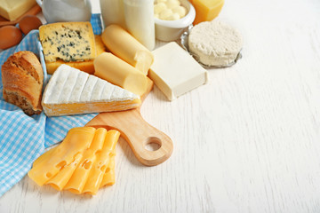Set of fresh dairy products on white wooden table