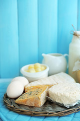 Set of fresh dairy products on blue wooden table, close up