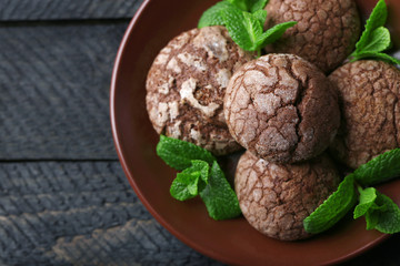 Chocolate chip cookie with mint on plate, closeup