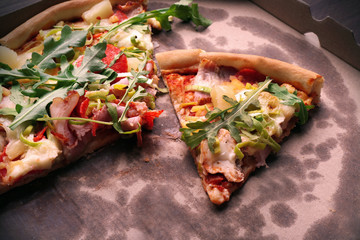 Sliced fresh pizza on cardboard background