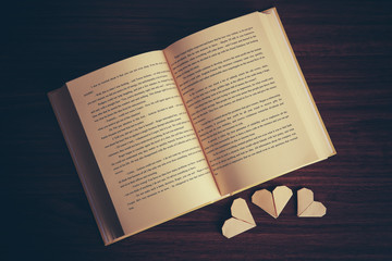 Fototapeta na wymiar Heart bookmarks for book on wooden background