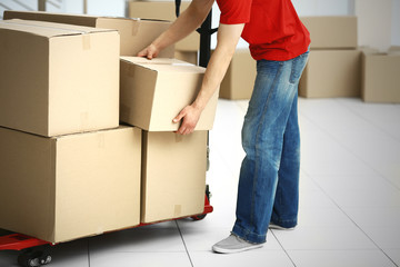 Man holding carton box in the room, close up