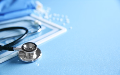 Stethoscope and medical equipment on a light blue background