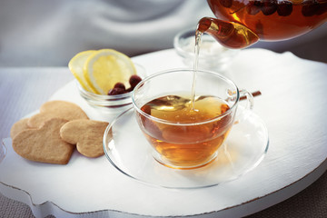 Pouring tea into cup, home atmosphere