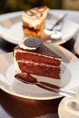 Close up chocolate cake bit on the plate in cafe