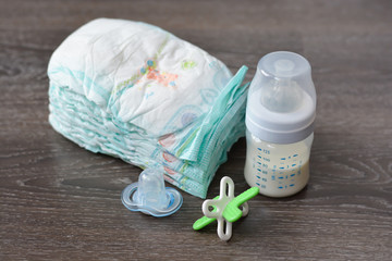 Diapers baby milk bottle and a pacifier