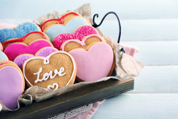 Tray with love cookies on blue wooden table background