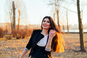 Beautiful business lady in a sunny park. Portrait