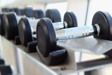 Fototapeta na wymiar Dumb bells lined up in fitness room