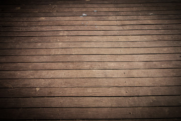 Old and weathered dark brown wood plate floor