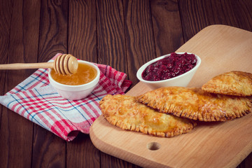 Freshly baked homemade scone with raspberry jam on a white plate