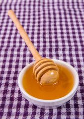 honey and spoon on the tablecloth