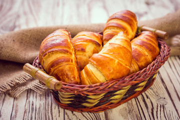 fresh croissants on wooden table