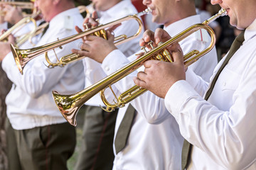 military musicians blowing gold trumpets