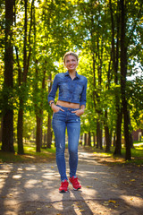 Smiling young woman in denim clothes