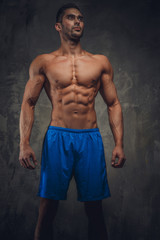 Fototapeta premium Shirtless muscular man in a blue shorts.