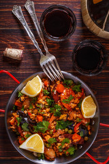 Paella with chicken, chorizo, seafood, vegetables and saffron se