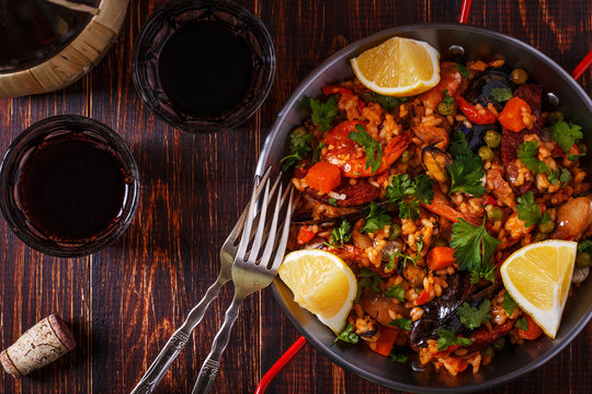 Paella with chicken, chorizo, seafood, vegetables and saffron se