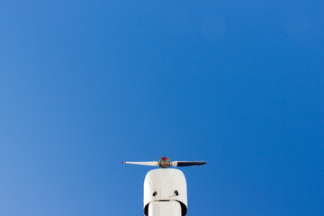 Propeller plane on blue sky background