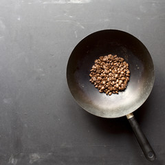 Fragrant fried coffee beans on black background. Close up, top view