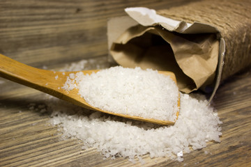 Large sea salt on wooden background