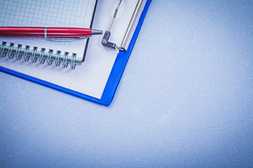 Red ballpoint pen checked copybook note pad office concept