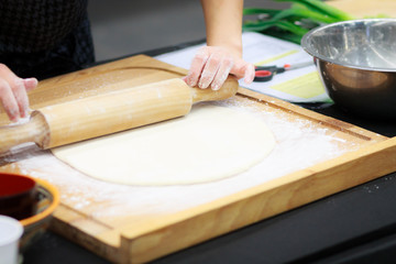 Preparing dough with the roller in a kitchen