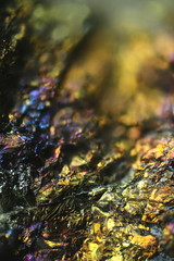 Microscope image of colorful copper ore. This is copper sulphide called Chalcopyrite, It has the chemical formula (CuFeS2).