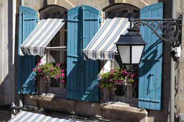 France provence style cottage house building windows blue shutters striped canopy and flower box...