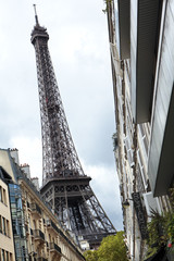 Eiffel Tower Paris France viewed from busy Paris street with trditional apartment buildings photo
