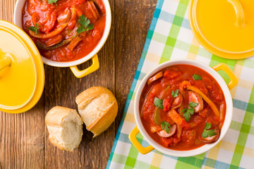 Delicious letcho with fresh vegetables, served in a yellow pot w