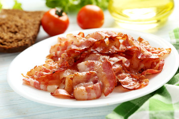 Crispy strips of bacon on a blue wooden background