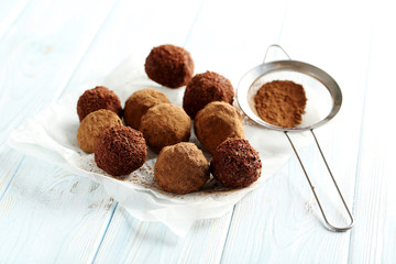 Sweet chocolate truffle on a blue wooden table