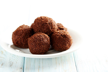 Sweet chocolate truffle on a blue wooden table