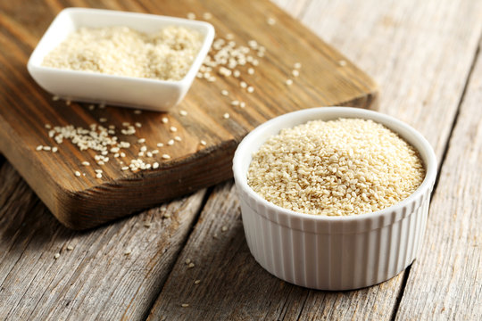 Sesame seeds on a grey wooden table