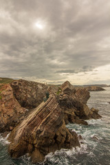 Monument on the rocks by the sea of Philippe Cousteau, Gijon, Spain