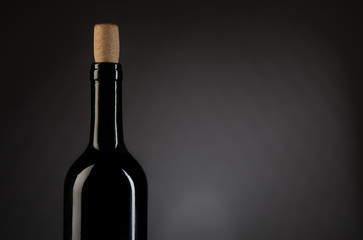 Wine bottle on dark studio background