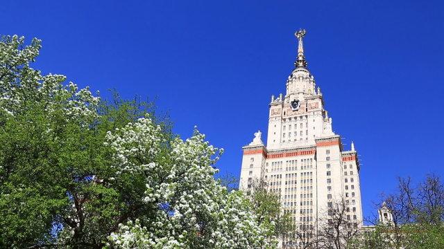 Spring gardens near the main building of MSU (Moscow State University) under clear blue sky.