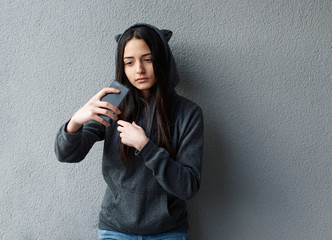 Fototapeta premium Young pretty girl taking selfie against of textured wall