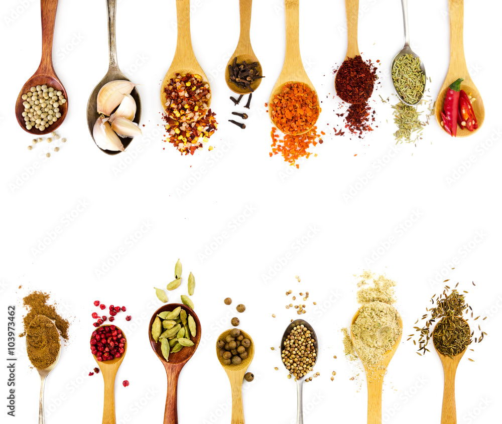 Wall mural spices in spoons isolated on white background.