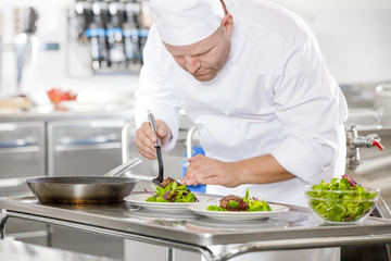 Obraz na płótnie Canvas Professional chef prepare steak dish at restaurant