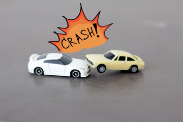 Car crashing accident , small toy car crashing , car insurance concept.