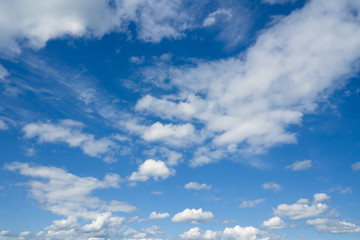 Cloudscape over horizon. Blue sky and white clouds.