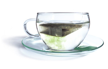 Green tea with tea bag. Green tea, coloring the hot water.