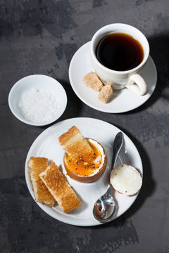 boiled egg, cup of coffee and crispy bread, vertical, top view