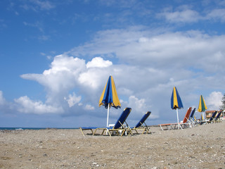 Beach sunbeds and parasols on a sandy beach