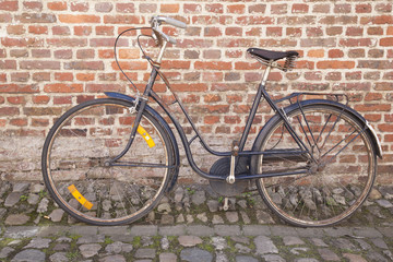 Bicycle on Cobble Stone against Brick Wall; Groot Begijnhof; Leu