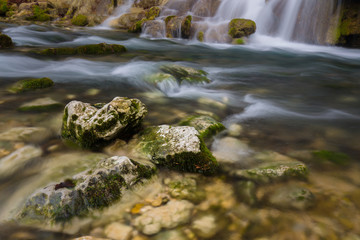 Naklejka na ściany i meble Beautiful waterfalls and mountain stream in Transylvania, in early spring