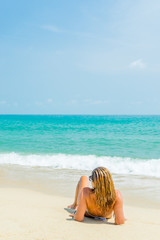Woman suntanning on the beach on the tropical beach