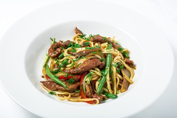 Thai noodles with ostrich meat, green beans and mushrooms.